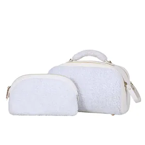 Detail view of a white fuzzy sherpa makeup bag set featuring premium gold zippers