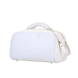 Detailed side view of a white fleece cosmetic bag with gold zippers and sherpa handle