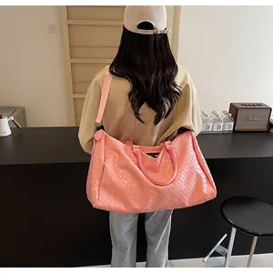 Stylish pink woven travel bag for women, ideal for fitness and short business trips.