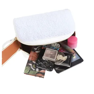 Spacious white fluffy makeup bag showing various cosmetics and a tablet inside.