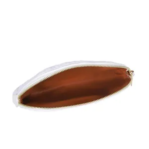 Detail showing the spacious interior and brown lining of this white fuzzy makeup bag