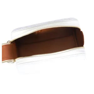 Detailed view of the large capacity white fluffy makeup bag showing the brown interior space.