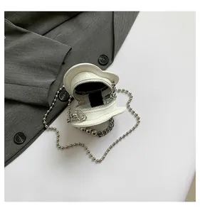 Detailed interior view of a white heart shaped mini chain purse on a gray fabric background