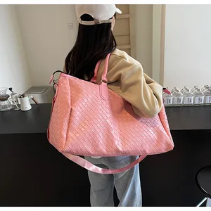 Pink woven travel bag for women, stylish large capacity duffel for weekend trips