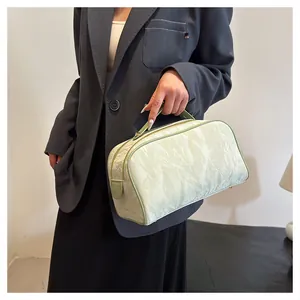 Elegant large capacity pistachio makeup bag with wrinkled texture for travel toiletries.