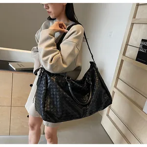 Large black woven travel bag for women, ideal for fitness, gym, and weekend trips.