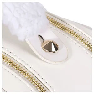Detailed close-up showing golden zippers and plush white trim on a stylish cosmetic bag