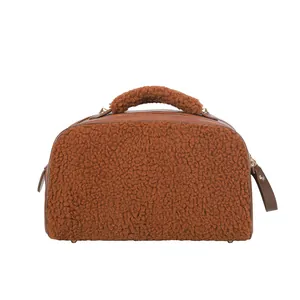 Detailed view of a brown teddy fleece cosmetic bag with premium leather zipper pulls
