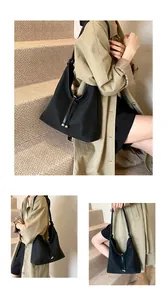 Multi-angle views of a minimalist black large capacity tote bag worn by a model