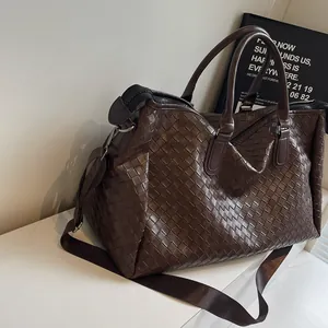 Large brown woven travel duffle bag for short trips and gym use