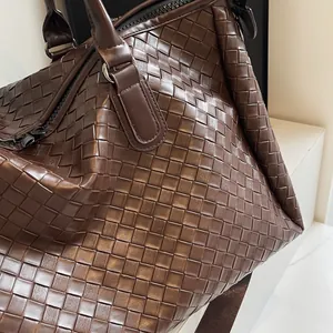 Close-up of the premium brown woven texture on this stylish women's travel luggage bag