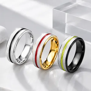 Close-up of brushed dual-color couple rings with vibrant oil-drip inlay details