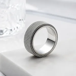 Detailed view of silver mesh textured stainless steel spinner ring for stress relief