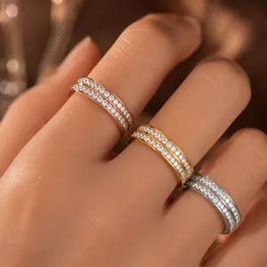 Detail view of three zircon eternity rings in gold, rose gold, and silver finishes