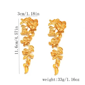 Large gold-toned metallic floral drop earrings with detailed measurement annotations