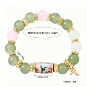 Close-up view of a hummingbird beaded bracelet featuring 16cm adjustable length and 29g weight.