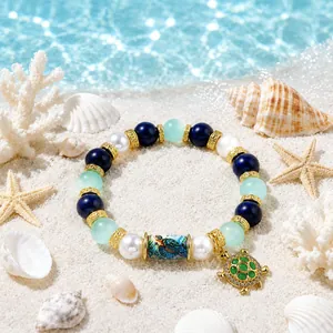 Close-up view of a mythical ocean DIY bead bracelet featuring a green sea turtle charm