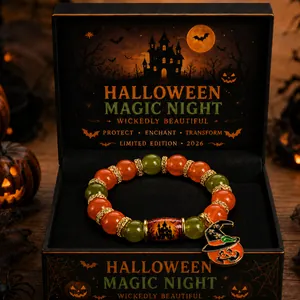 Detailed shot of Halloween beaded bracelet with pumpkin witch hat charm in gift box
