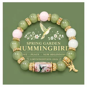 Detailed view of handmade hummingbird beaded bracelet with pastel and green beads.