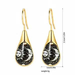 Detailed view of teardrop earrings featuring sun and moon graphics with dimensions