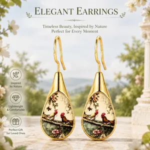Macro view of teardrop earrings with intricate rooster and floral pattern design