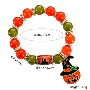 Handmade Halloween beaded bracelet with orange and green crystals and pumpkin charm