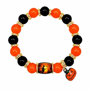 Spooky Halloween beaded bracelet with orange pumpkin charm and witch forest design