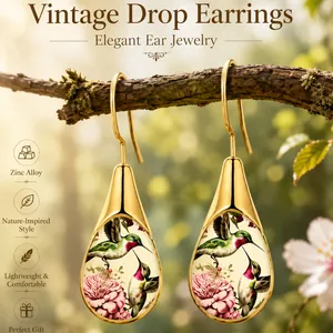 Macro view of vintage zinc alloy drop earrings featuring hummingbird and flower art
