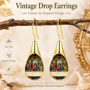 Detailed view of vintage gold teardrop earrings featuring The Last Supper miniature