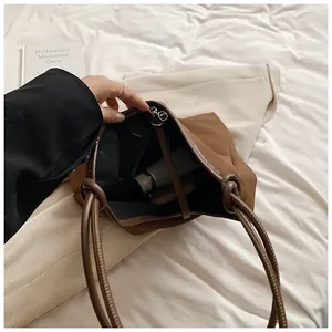 Detailed interior view of a large capacity brown tote bag showing spacious storage.
