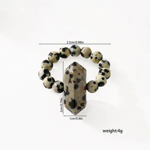 Detail of spotted natural stone beaded ring with hexagonal column measurements.