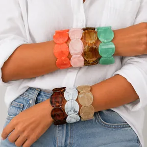 Detailed view of colorful irregular resin bracelets featuring vibrant marbled textures