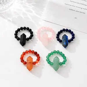 Macro view showing various colors of natural stone beaded rings with crystal pillars.