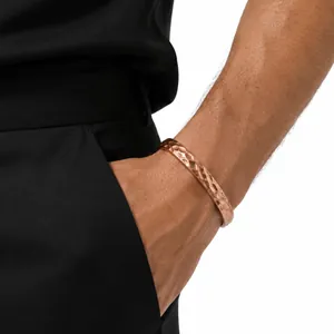Detail shot of men's hammered copper magnetic bracelet worn on wrist by pocket