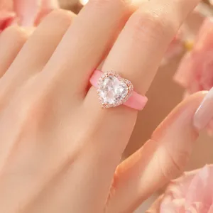 Primer plano de un anillo de silicona rosa con un circón brillante en forma de corazón