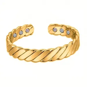 Close-up detail of a gold twisted magnetic cuff bracelet with inner healing magnets