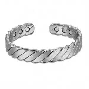 Silver twisted cuff magnetic therapy bracelet for men and women on white background.