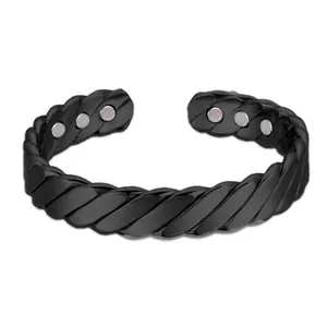 Detail showing the matte black twisted texture and internal magnets of the cuff bracelet
