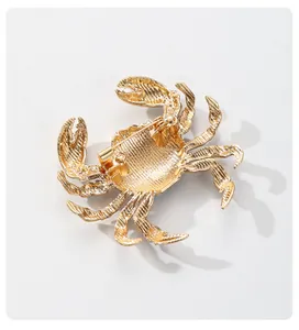 Detailed macro view showing the sturdy back pin mechanism of a golden crab brooch.