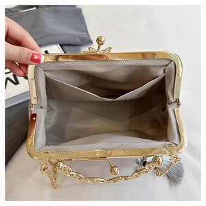 Detailed interior view of evening clutch bag showing the chevron pattern lining and pocket