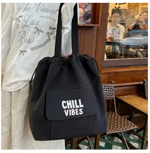 Zwarte nylon shopper met trekkoord en voorvak voorzien van de 'CHILL VIBES' print