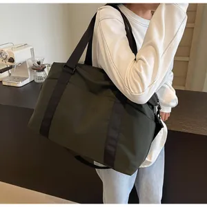 Lifestyle view of an olive green large capacity travel shoulder bag for short trips