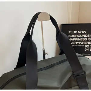 Close-up of dark green travel bag handle and durable top zipper detail