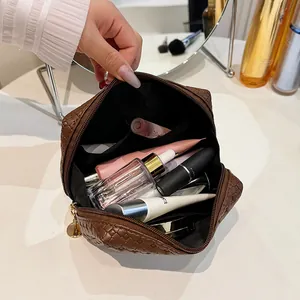 Detailed view of a brown woven square cosmetic bag showing its spacious interior capacity