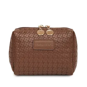 Close-up of brown woven texture cosmetic bag with gold-tone double zippers