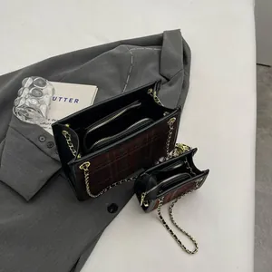 Detailed interior view of plaid wool handbag set with elegant gold chain straps