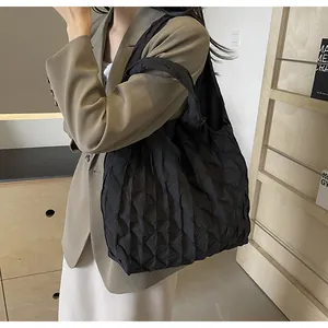 Detail view of the black pleated texture on a large Korean-style shoulder tote bag.