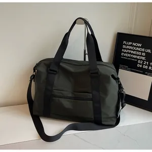 Large capacity dark green nylon travel duffel bag with black straps on a marble surface.
