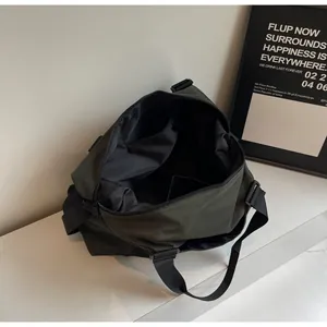 Internal view of a large olive green travel duffel bag showing spacious compartments