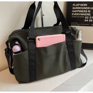 Detailed view of olive green travel bag showing side pockets with various accessories
